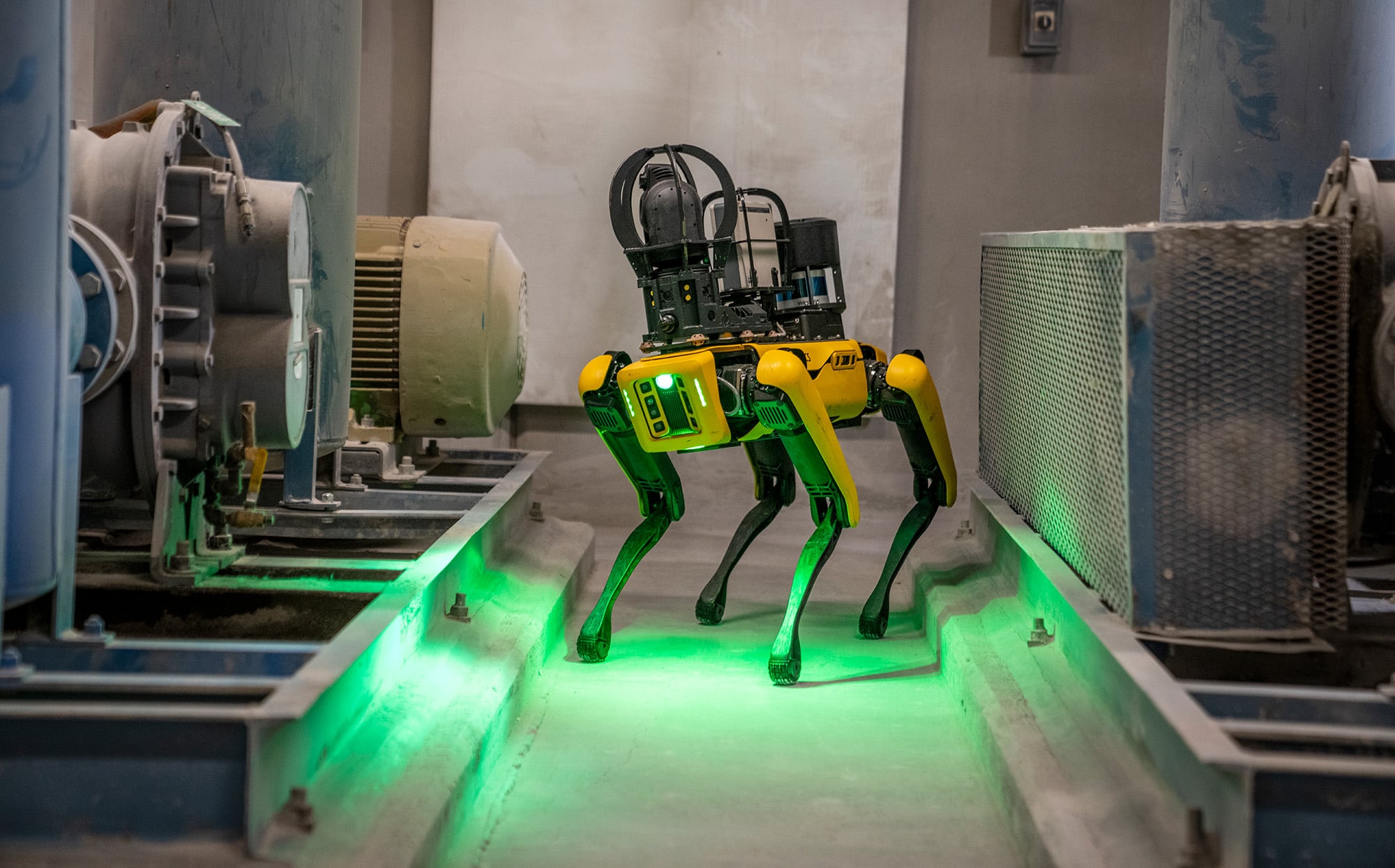 A quadruped inspection robot walking an industrial route.